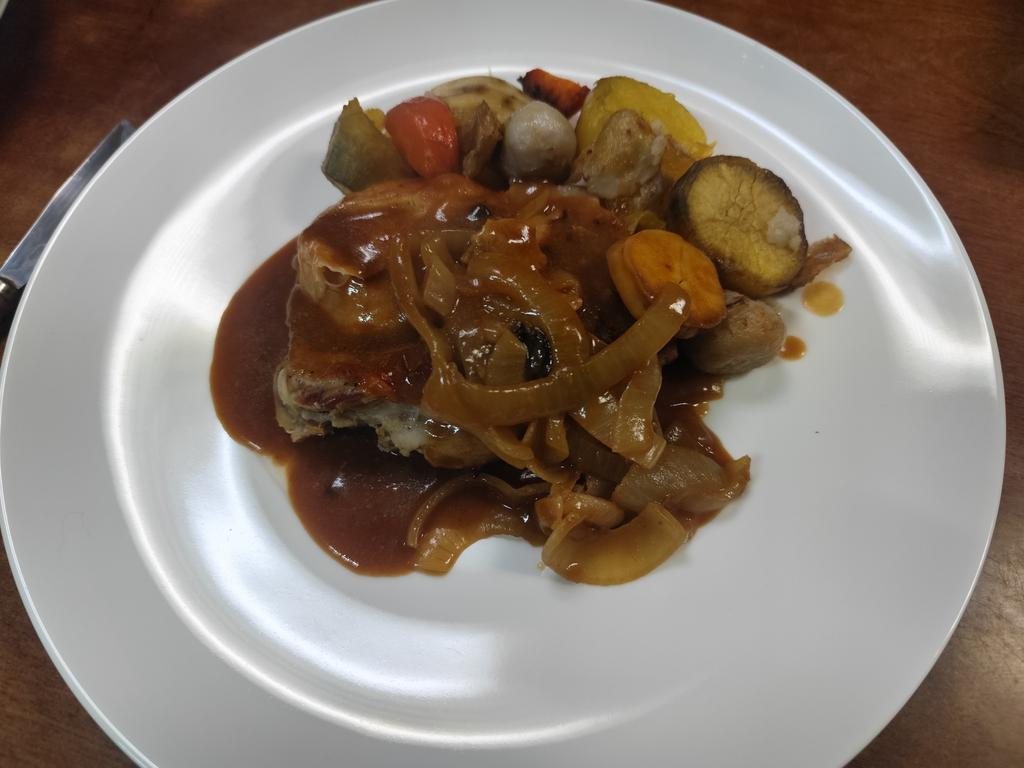Braised meat with onions, roast potatoes and gravy