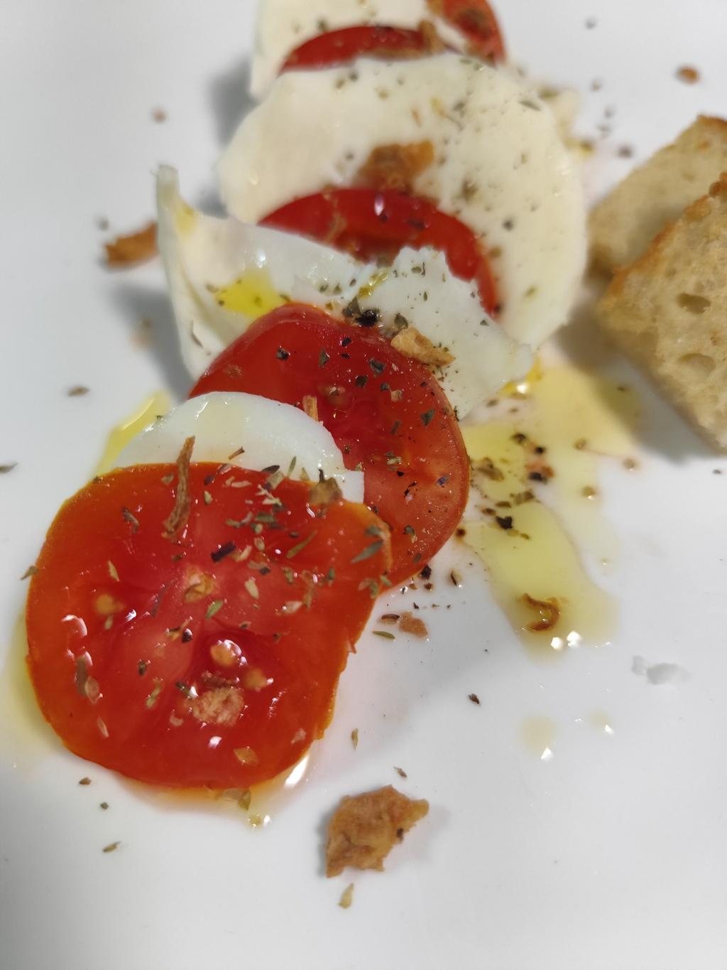 Tomato and mozzarella with olive oil, herbs, and bread