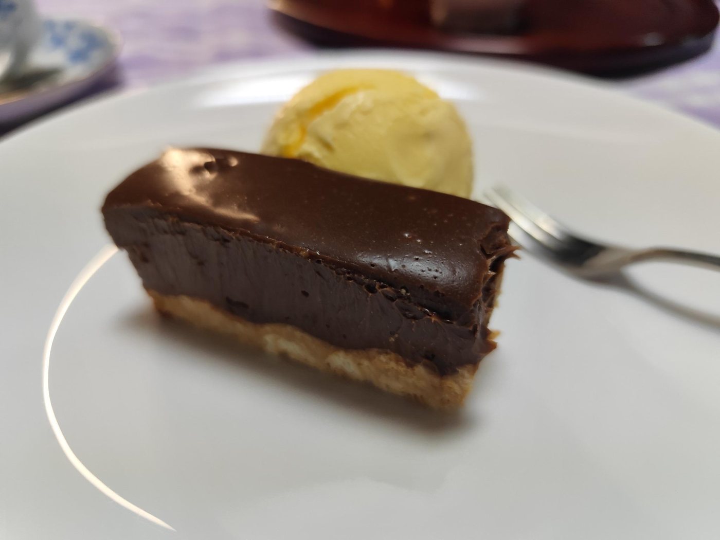 Chocolate tart with a scoop of vanilla ice cream