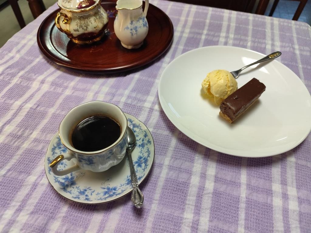 Coffee in a blue floral cup, with chocolate dessert and ice cream