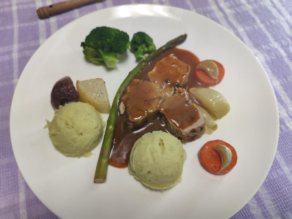 Pork medallions in gravy with mash, asparagus, roast carrot and broccoli