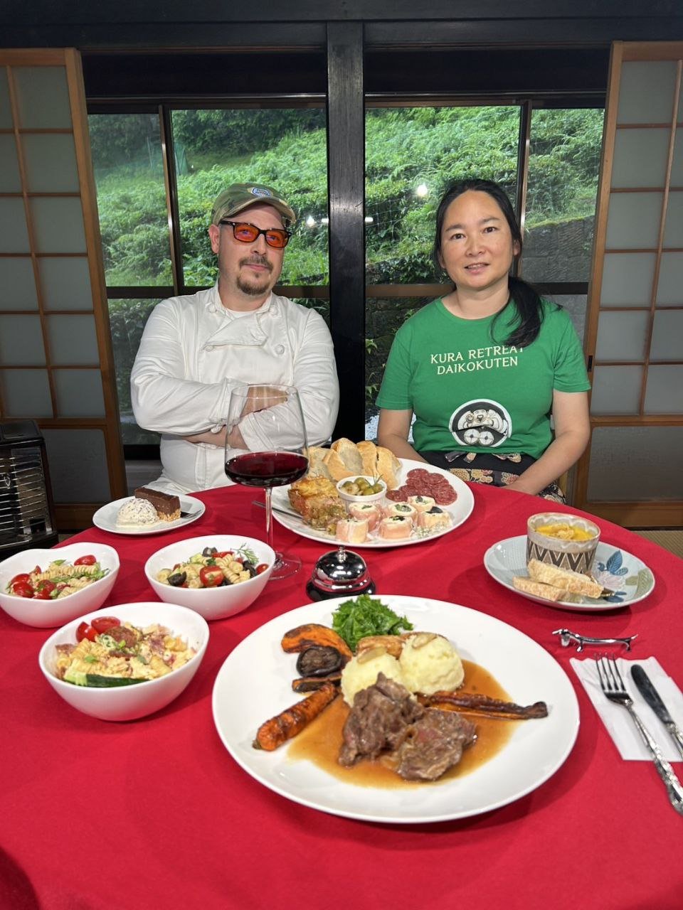 Shem in chef's whites and Mari at a set table in the Japan Rooms