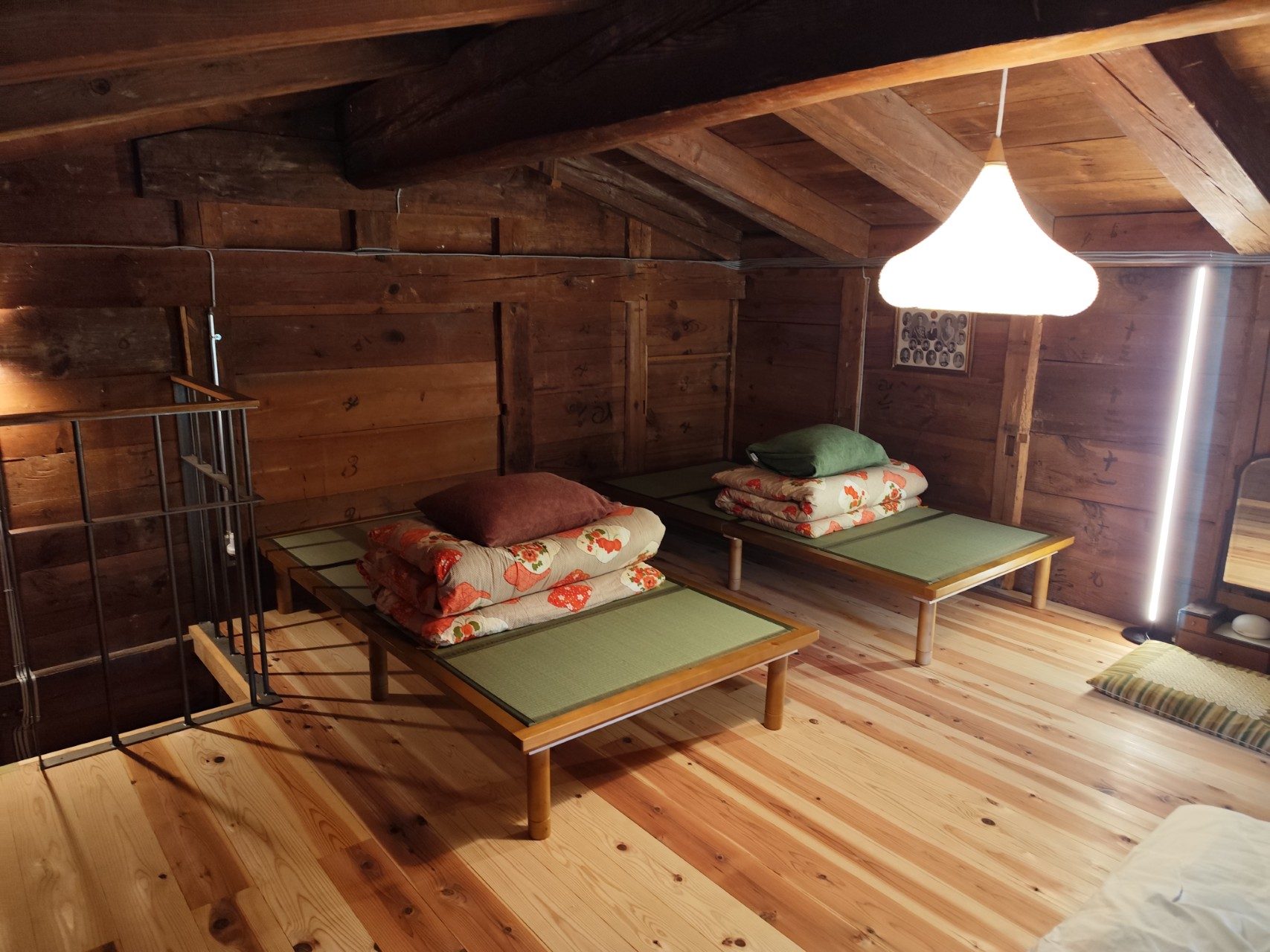 Tatami platforms with folded futons in the sleeping loft