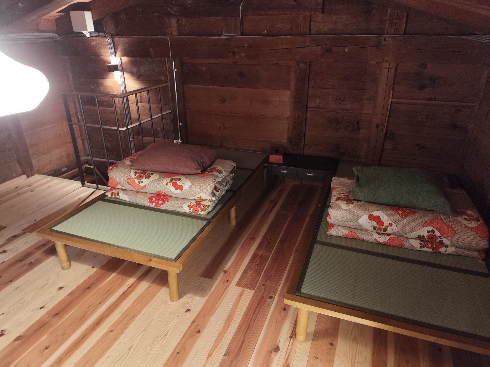 Two tatami beds with folded floral futons